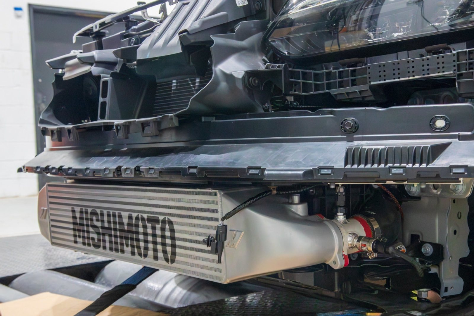 Mishimoto intercooler installed on the test Civic Si with the front grille removed