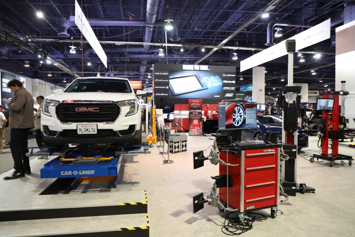 The Snap-on Total Shop Solutions booth at the SEMA Show, with a GMC truck on a Car-O-Liner lift and the John Bean 4400 alignment system in the foreground.